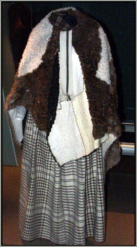 A replica of a Viking-era dress on display at the Danish National Museum. Most Viking clothing was made or wool or linen. In rare instances, clothes were made of imported silk.  Most Viking-era dyes were made from plants, though some were made from insects. The royal blue of the cloth on this outfit was dyed with color extracted from leaves of the European woad plant. The cross hatches were colored red with dye from the root of the madder plant. 