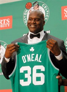   Boston Celtics newly signed basketball player Shaquille O'Neal holds up his new jersey at a news conference on Tuesday, Aug. 10, 2010, in Waltham, Mass. (Greg M. Cooper/AP)