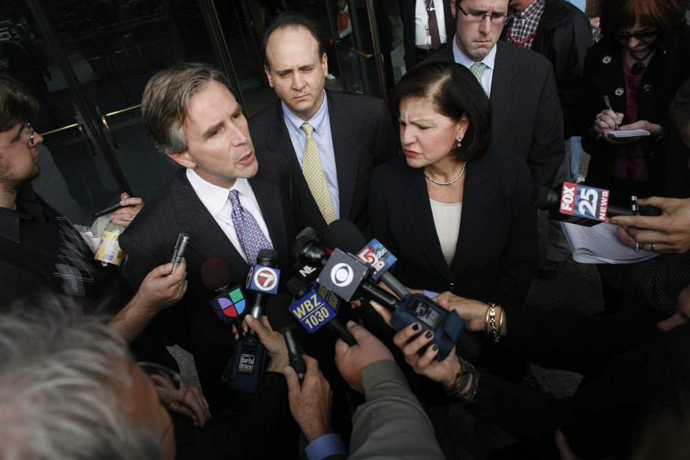Prosecutor John McNeil, left, and U.S. Attorney Carmen Ortiz talk to reporters outside the Moakley federal courthouse Friday after City Councilor Chuck Turner was found guilty on all counts in a corruption trial. (Dominick Reuter for WBUR)