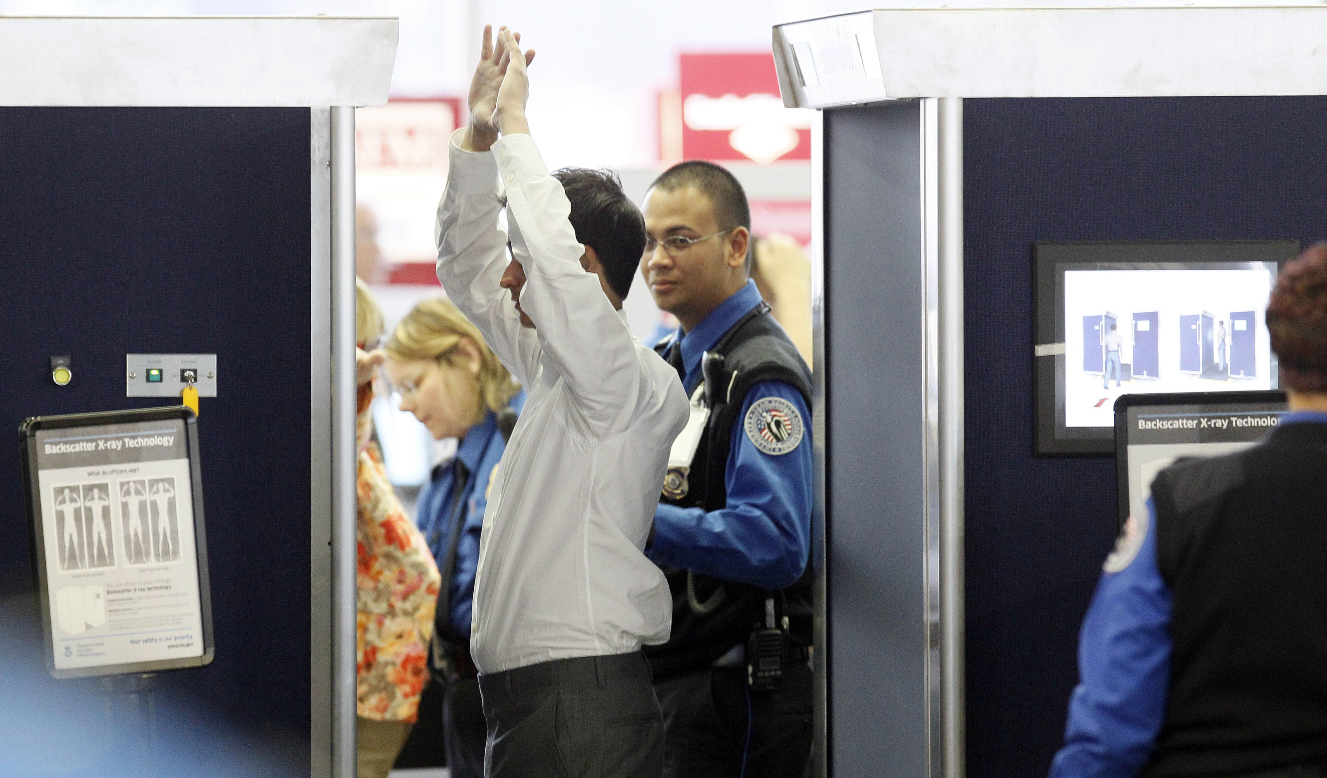 A man undergoes a full-body scan at Chicago's O'Hare airport, where I'll be next week. (AP)
