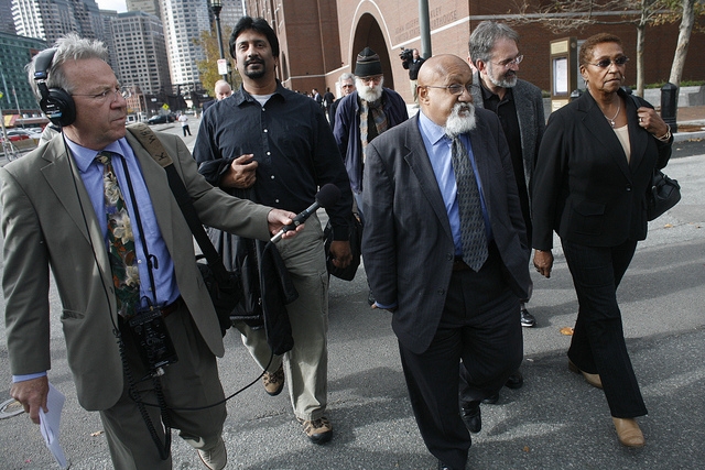 City Councilor Chuck Turner, with WBUR’s David Boeri at left, leaves the Moakley federal courthouse Oct. 29th after being found guilty on all counts in a corruption trial. (Dominick Reuter for WBUR)