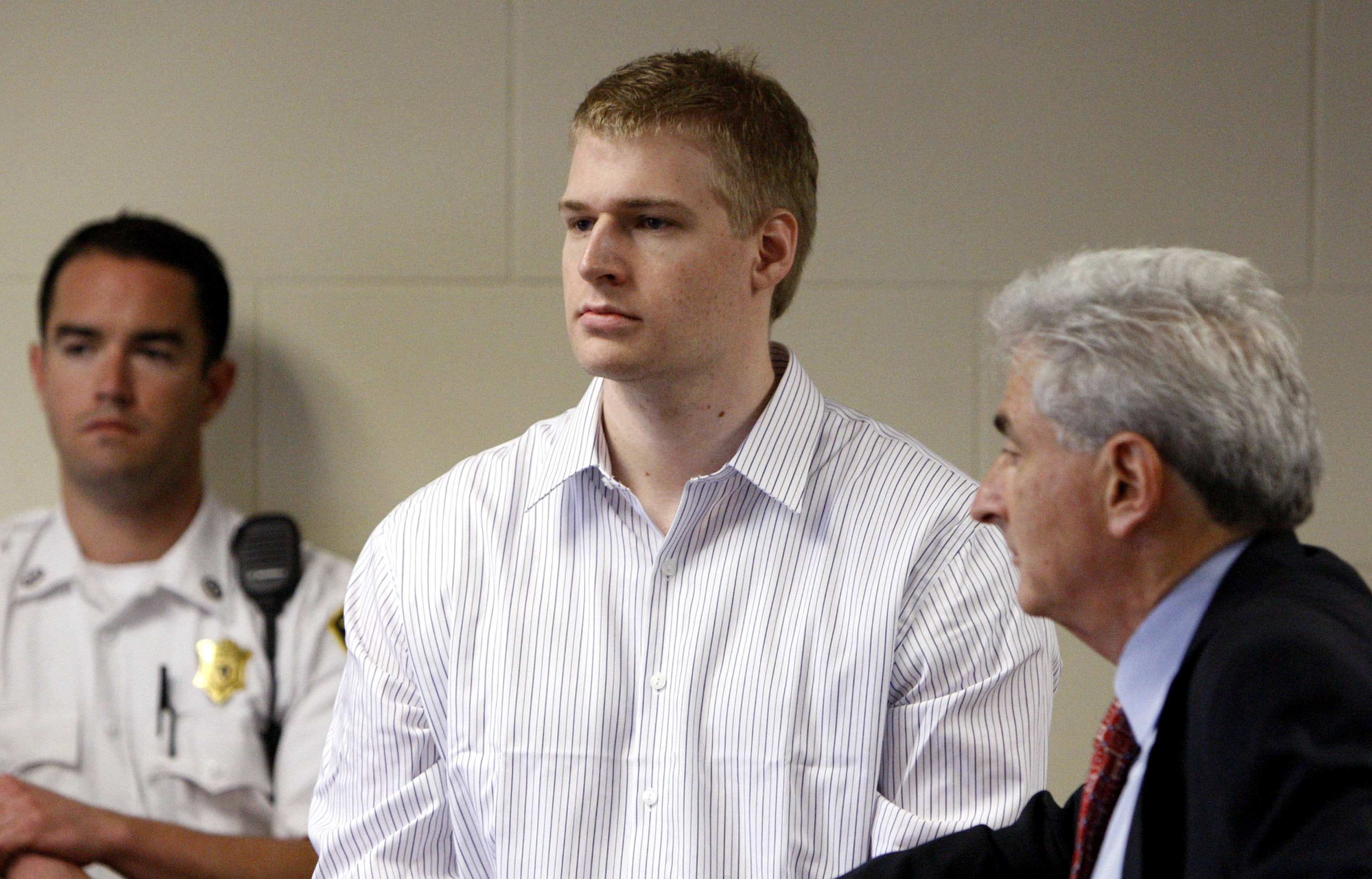 In this June 22, 2009 file photo, former Boston University medical student Philip Markoff, center, stands with his attorney John Salsberg, right, during his arraignment in Suffolk Superior Court in Boston. Officials confirmed that Markoff was found dead of apparent suicide in his jail cell Sunday, Aug. 15, 2010, in Boston. (Pool photo by Bizuayehu Tesfaye via AP)