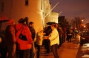 Volunteers and bakers took to the sidewalk to feed those waiting paitently to get in the venue. (Abby Conway/WBUR)
